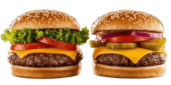 Two cheeseburgers side by side on a solid teal background, each with a sesame seed bun, beef patty, melted cheese, tomato slices, red onion, pickles, and leafy lettuce.